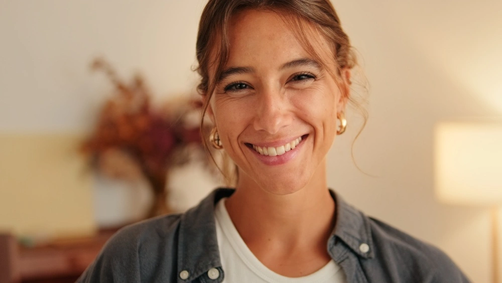 Smiling patient in a warm dental studio setting